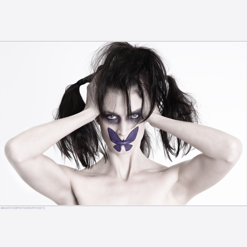 Butterfly - Facepainting over the mouth of a great model looking creepy holdig her hands to th e head - White but Dark - Photo © by Magistus