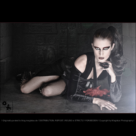 Gothic Beauty - Dark Fashion Composing with beautiful model lying on the floor in front of a ancinent gate wearing a black sexy dress with dark make-up styling - © by Magistus