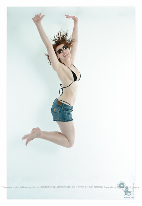 Jump - Fun in the Studio with beautiful and natural model wearing small bikini top and tight jeans hotpants - © by Magistus