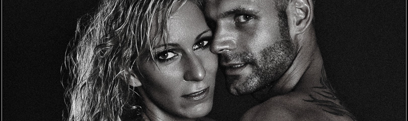 Lovers - Boy-Girl Low-Key Nude Art Shooting with two beautiful topless models posing half naked hugging each other wearing jeans. - © by Magistus