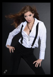 Sexy Fashion - Women in Male-Clothes Photoshoot with super female model wearing black pants braces and a white wide opened buttoned down shirt showing a lot of cleavage. - © by Magistus