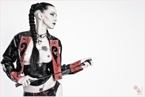 Black Rose - Fetish Nude Art Shooting with great model wearing a latex jacket and a whip showing her naked boobs and her black rose tattoo. - © by Magistus