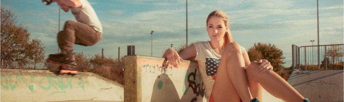 Summer n Skates - Outdoor Portrait Shooting on Skater Ground with fantastic blonde model in hotpants and a jumping skater in the Background. - © by Magistus