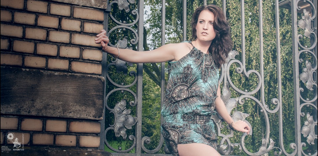 Summer Fashion posing in front of a fantastic metal gate showing a lot of her awesom long legs. - Fantastic Model on Location - © by MagistusFoto