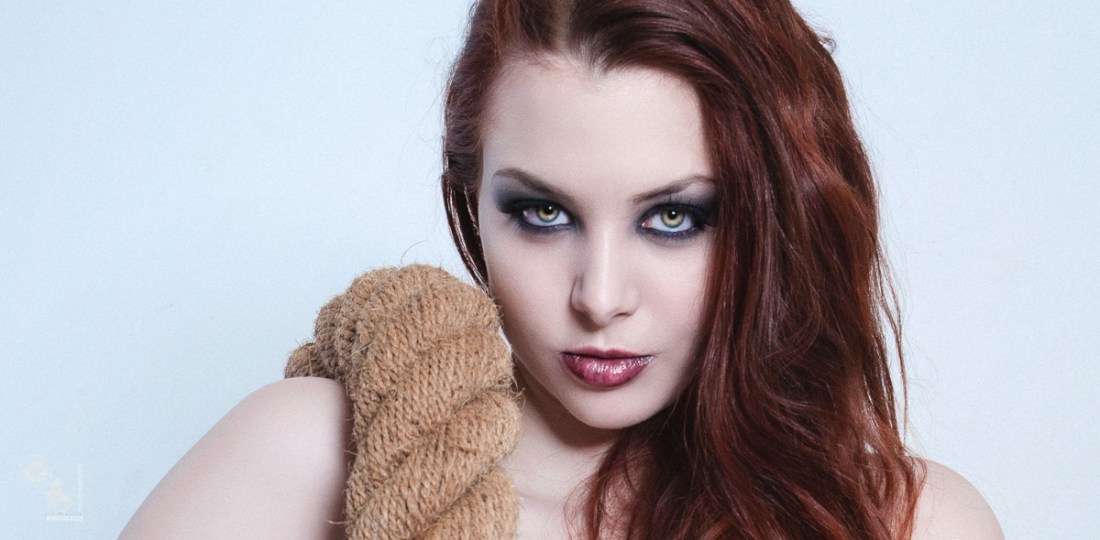 Classic Nude Art - Fantastic redhead Model is posing naked with a large rope - © by MagistusFoto