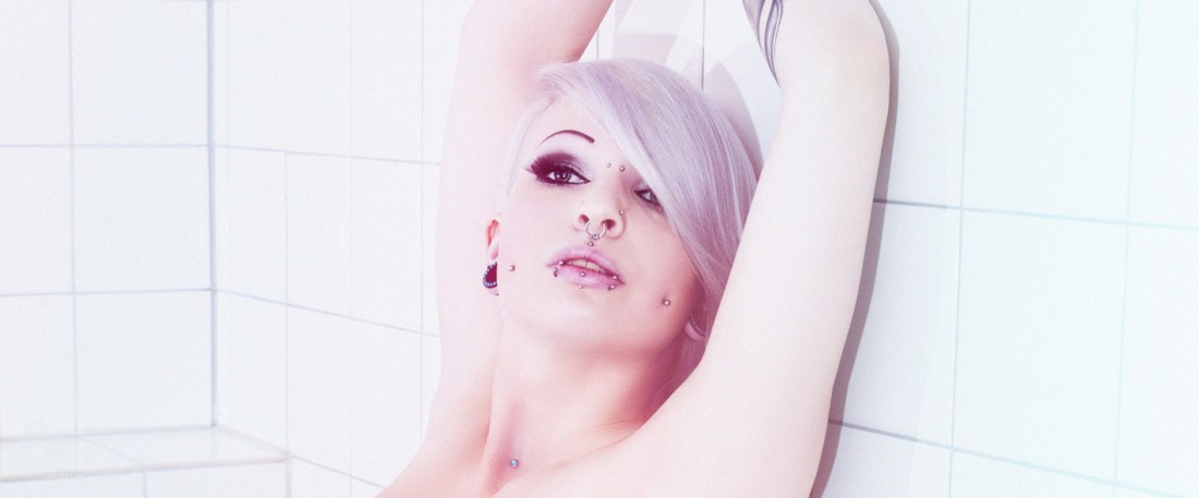 White Whitic - Super erotic nude art photo with alternative model Lilith Whitic posing naked against a white wall presenting her perfect body and naked boobs and a lot of piercings - © by Magistus