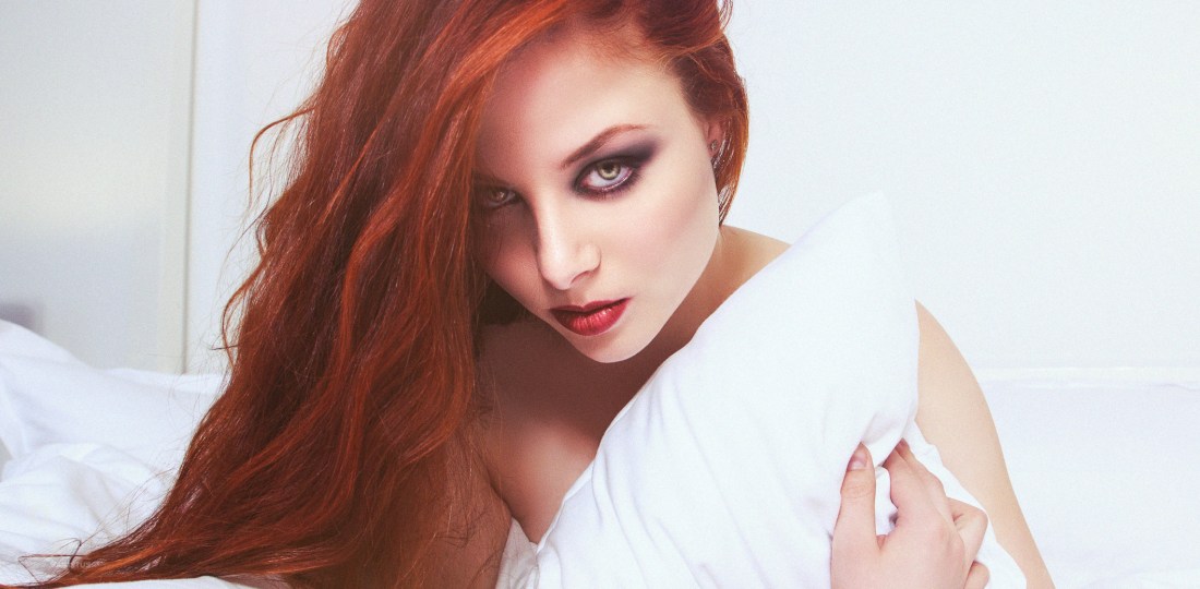 Red in White - Beautiful portrait of fantastic redhead model Moony Mara posing in a white bed on location - © by Magistus