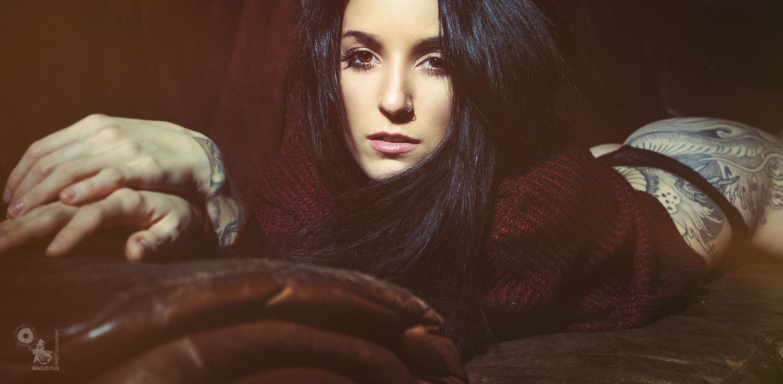 The Lounge - Super sexy model is relaxing on the couch showing her sexy booty and tattoos. - © by Magistus