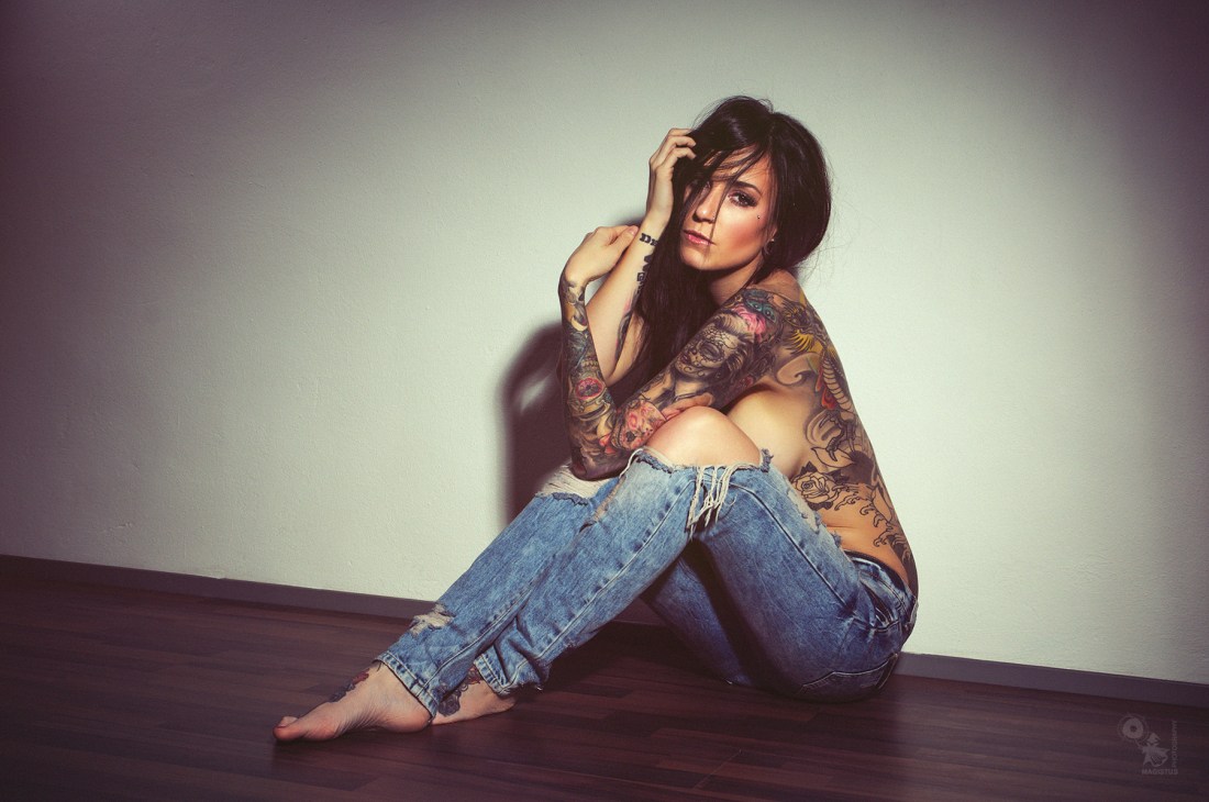 Kimmy - Super sexy tattoo model is sitting topless on the floor wearing vintage jeans showing fantastic sideboobs. - © by Magistus