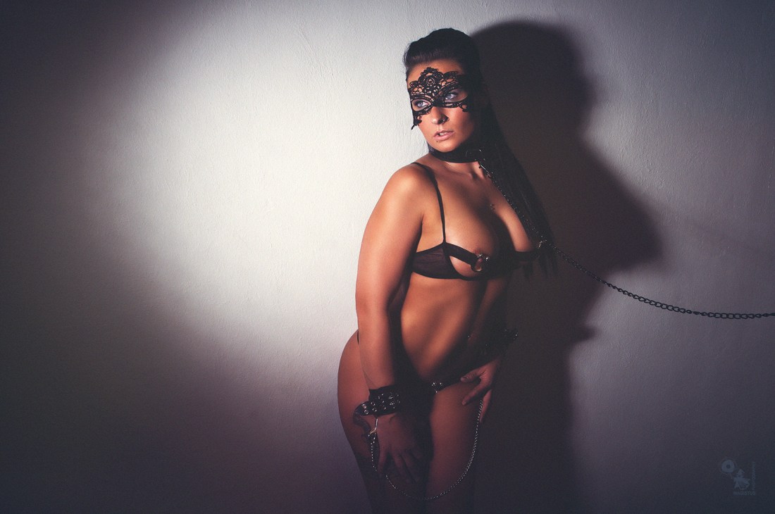 Fetish Lingerie - Super hot and sexy girl is posing in black lingerie showing her big boobs and cleavage handcuffed wearing a dog collar - © by Magistus
