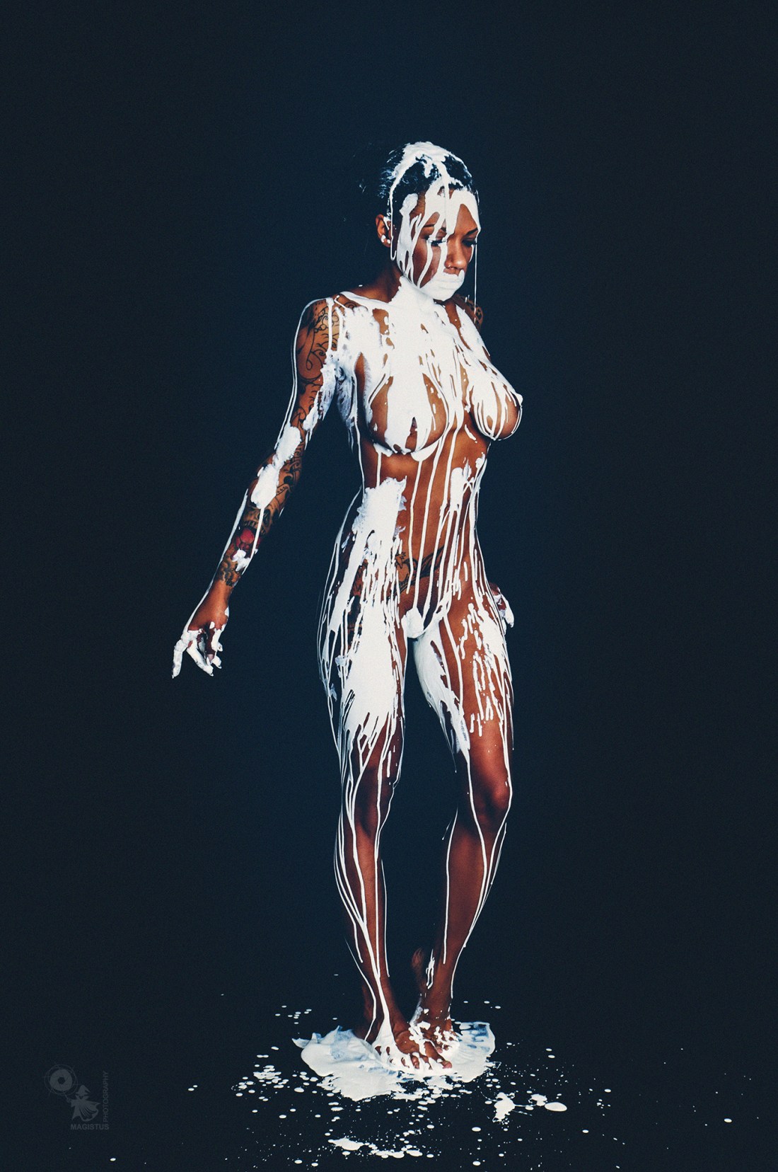 White Nude - Nude Art Bodypainting with a busty black model posing fully naked covered in white color dripping down her perfect body. - © by Magistus