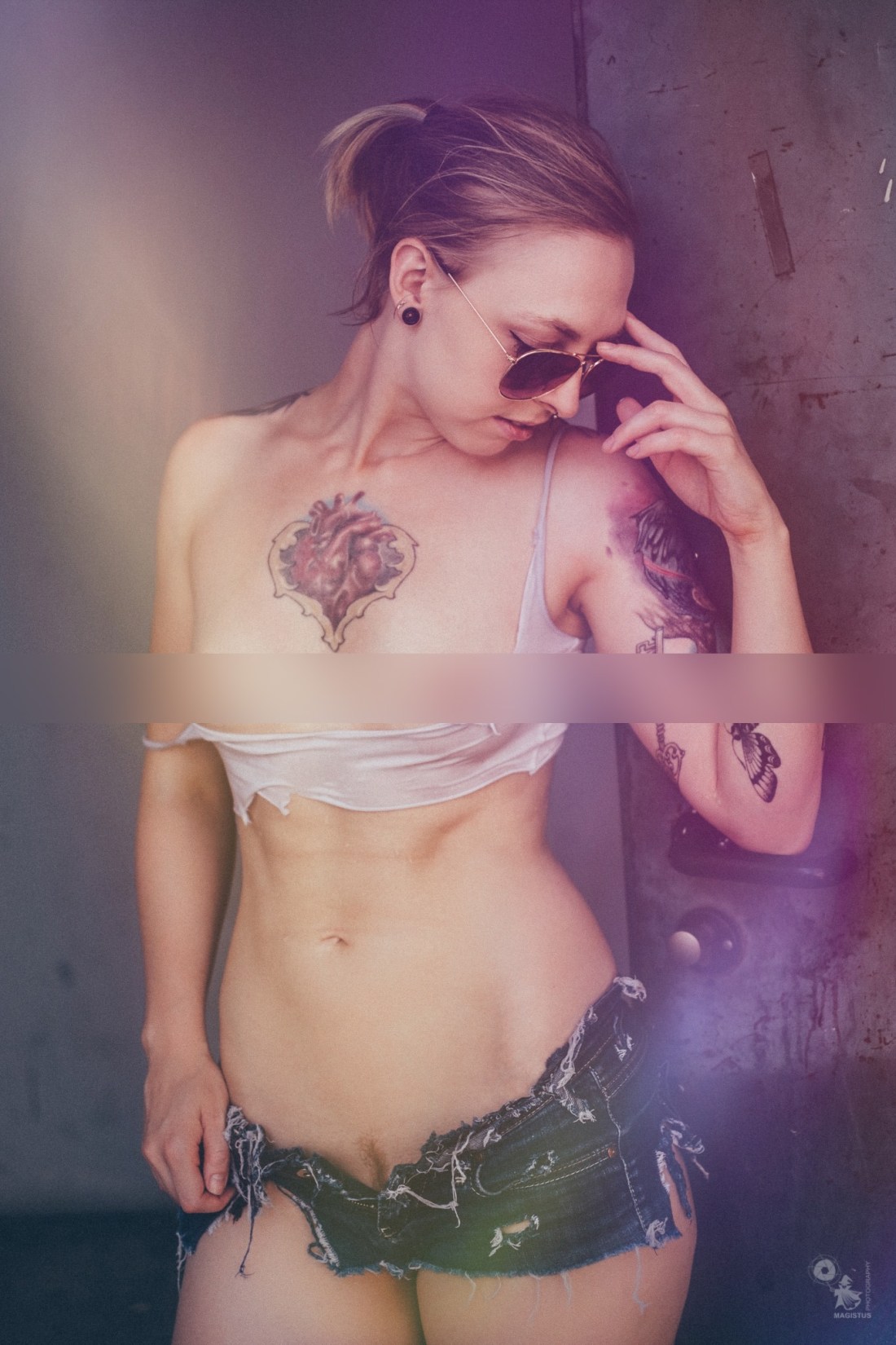 Sexy topless tattoo girl in hotpants