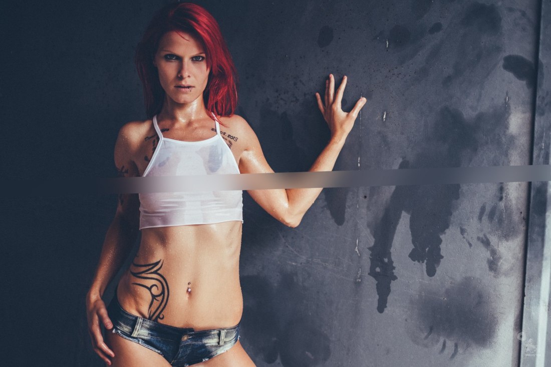 Super hot redhead is posing in a wet t-shirt showing her perfect boobs