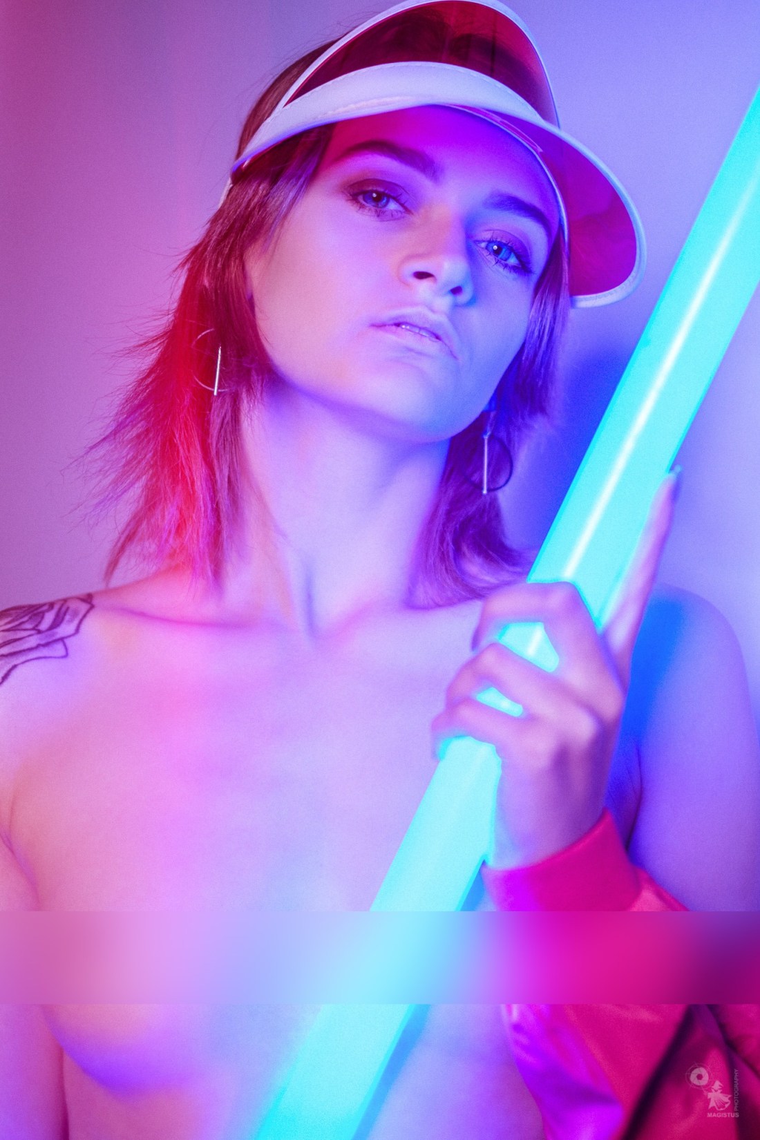 Super beautiful topless girl is posing in neon light