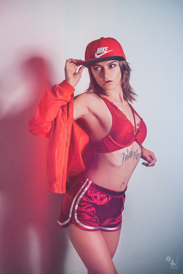 Hot and sexy model is posing in red retro lingerie and hotpants